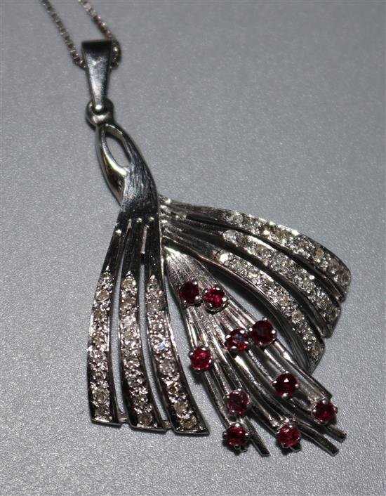 A 14ct white gold ruby and diamond set drop fan shaped pendant, on an 18ct gold chain, pendant 1.75in.